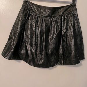 Faux leather eyelet mini skirt.